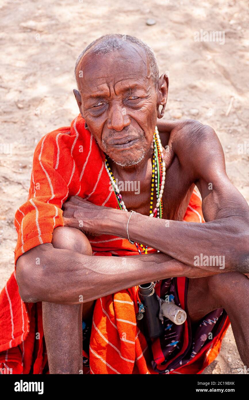 Close up portrait of a maasai old man, wearing traditional attire, member of the Samburu tribe, in a Samburu village. Samburu National Reserve. Kenya. Stock Photo
