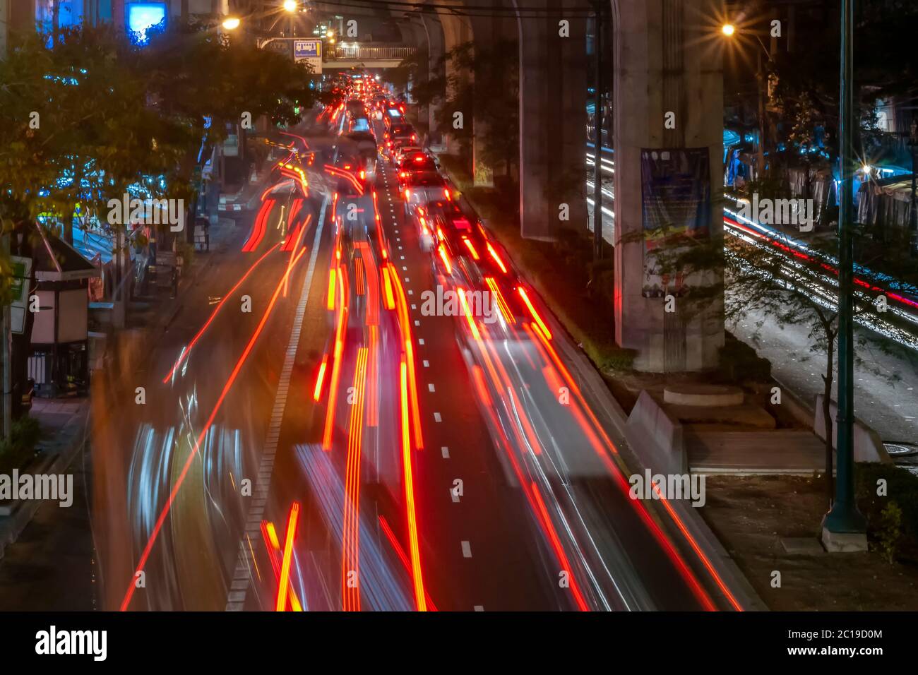 Beautiful nighttime image of traffic on Sukhumvit Road with long colored trails of moving car lights, Bangkok, Thailand Stock Photo