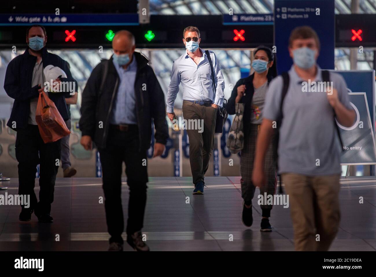 Passengers wearing face masks at Waterloo station in London as face