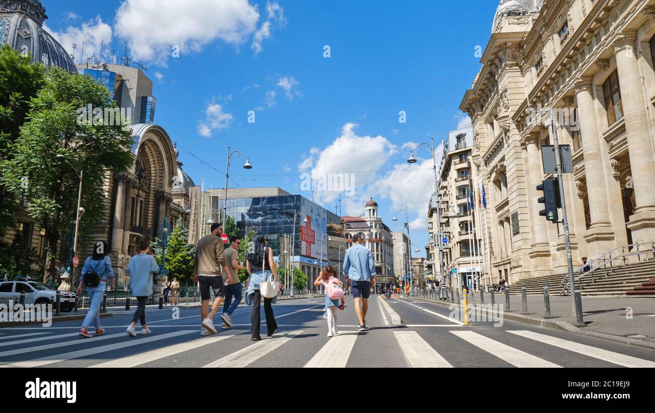 Bucharest, Romania - May 23, 2020: Car free zone on Calea Victoriei street, with pedestrians, cyclists, and people on scooters enjoying a sunny weeken Stock Photo