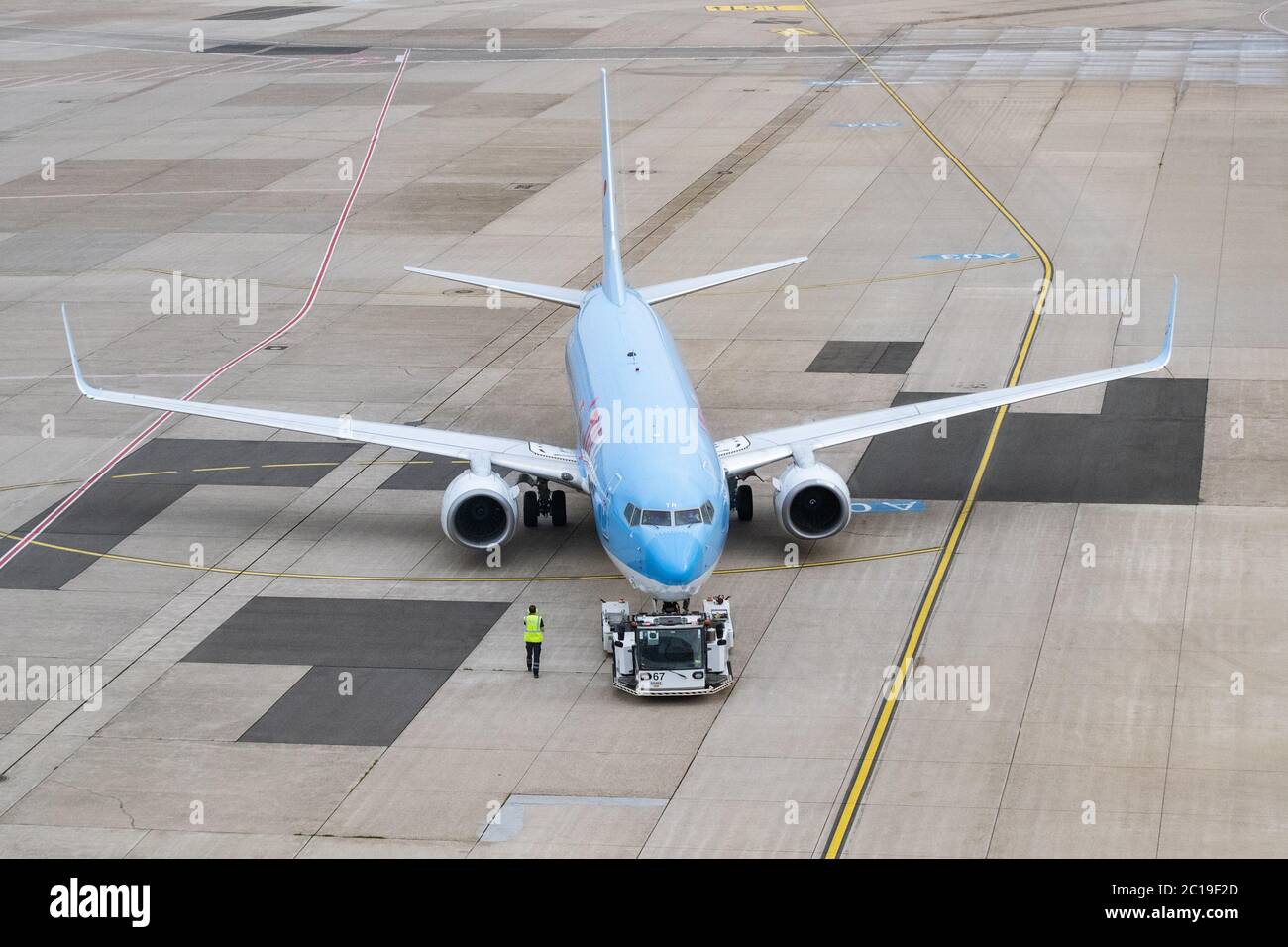 Duesseldorf, Germany. 15th June, 2020. A Tui aircraft is pushed out of its parking position on the apron of Düsseldorf Airport for Flight X3 2312 to Mallorca. After the travel warning for 27 European countries was lifted in the night to Monday (15.06.2020), this morning for the first time a plane with holidaymakers took off from Düsseldorf Airport after a weeks-long corona break. According to an airport spokesman, Tui-Flight X3 2312 to the Mediterranean island of Mallorca took off at 8.55 a.m. - with a 45-minute delay. Credit: Marcel Kusch/dpa/Alamy Live News Stock Photo