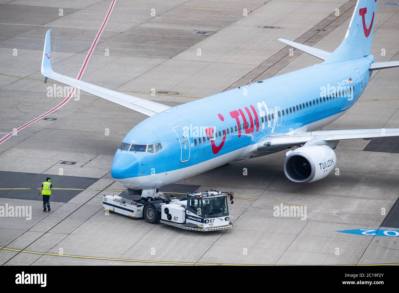Duesseldorf, Germany. 15th June, 2020. A Tui aircraft is pushed out of its parking position on the apron of Düsseldorf Airport for Flight X3 2312 to Mallorca. After the travel warning for 27 European countries was lifted in the night to Monday (15.06.2020), this morning for the first time a plane with holidaymakers took off from Düsseldorf Airport after a weeks-long corona break. According to an airport spokesman, Tui-Flight X3 2312 to the Mediterranean island of Mallorca took off at 8.55 a.m. - with a 45-minute delay. Credit: Marcel Kusch/dpa/Alamy Live News Stock Photo
