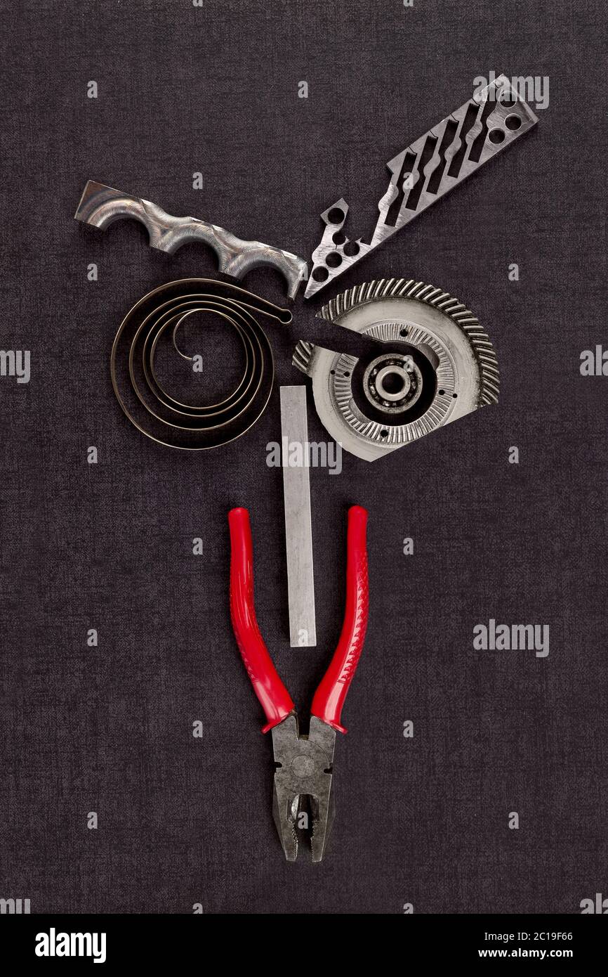 Screws, cogwheels and mechanical components on concrete. Stock Photo