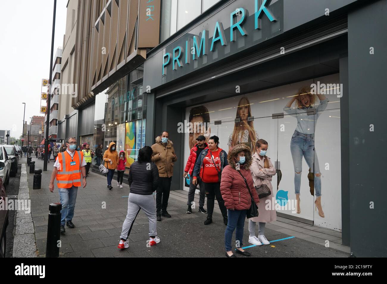 Shoppers wearing face masks in line for Primark in Newcastle as non-essential shops in England open their doors to customers for the first time since coronavirus lockdown restrictions were imposed in March. Stock Photo