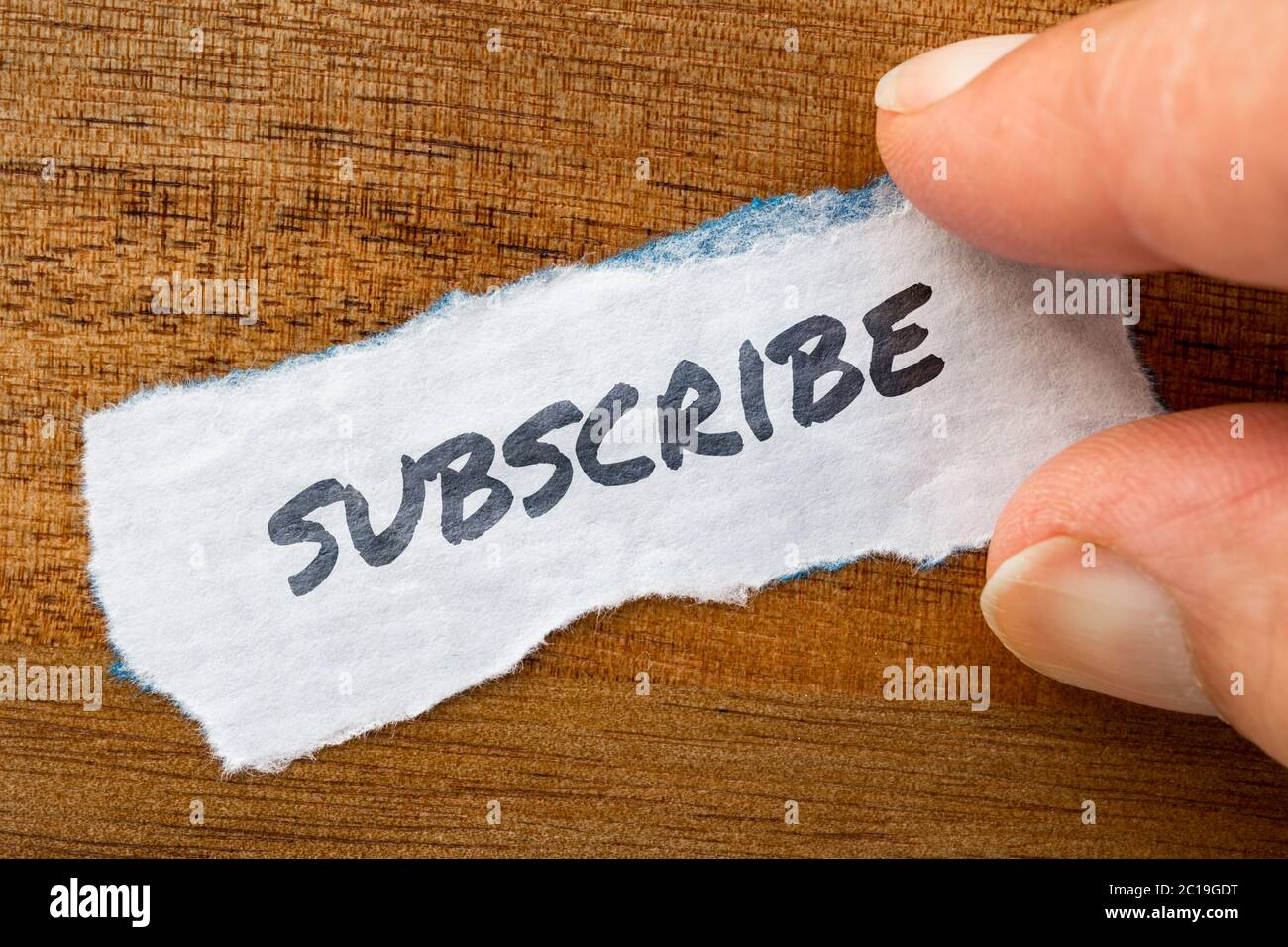 Subscribe concept and theme written on old paper on a grunge background Stock Photo