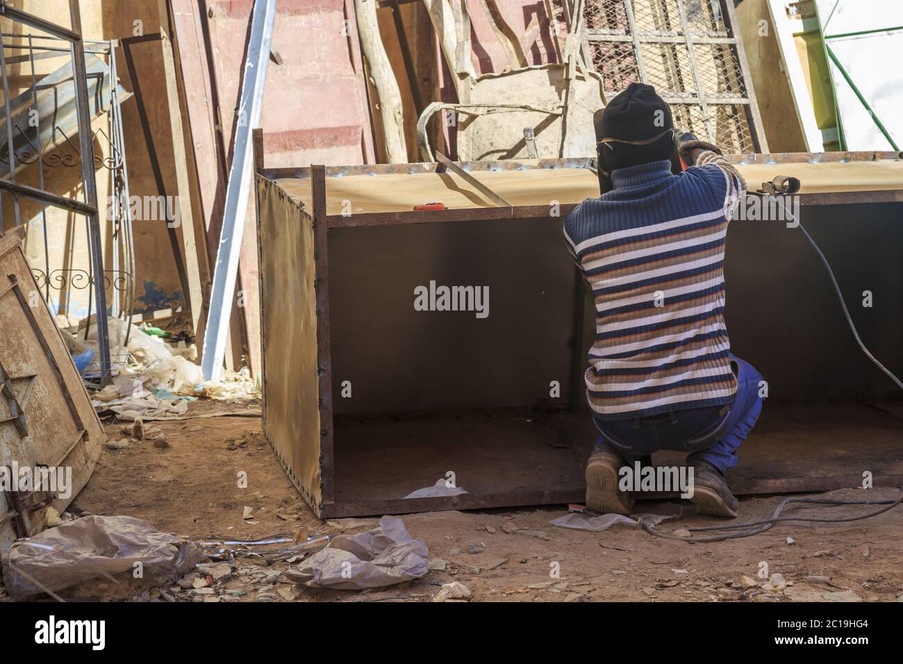 Rear view of welder using welding machine Stock Photo