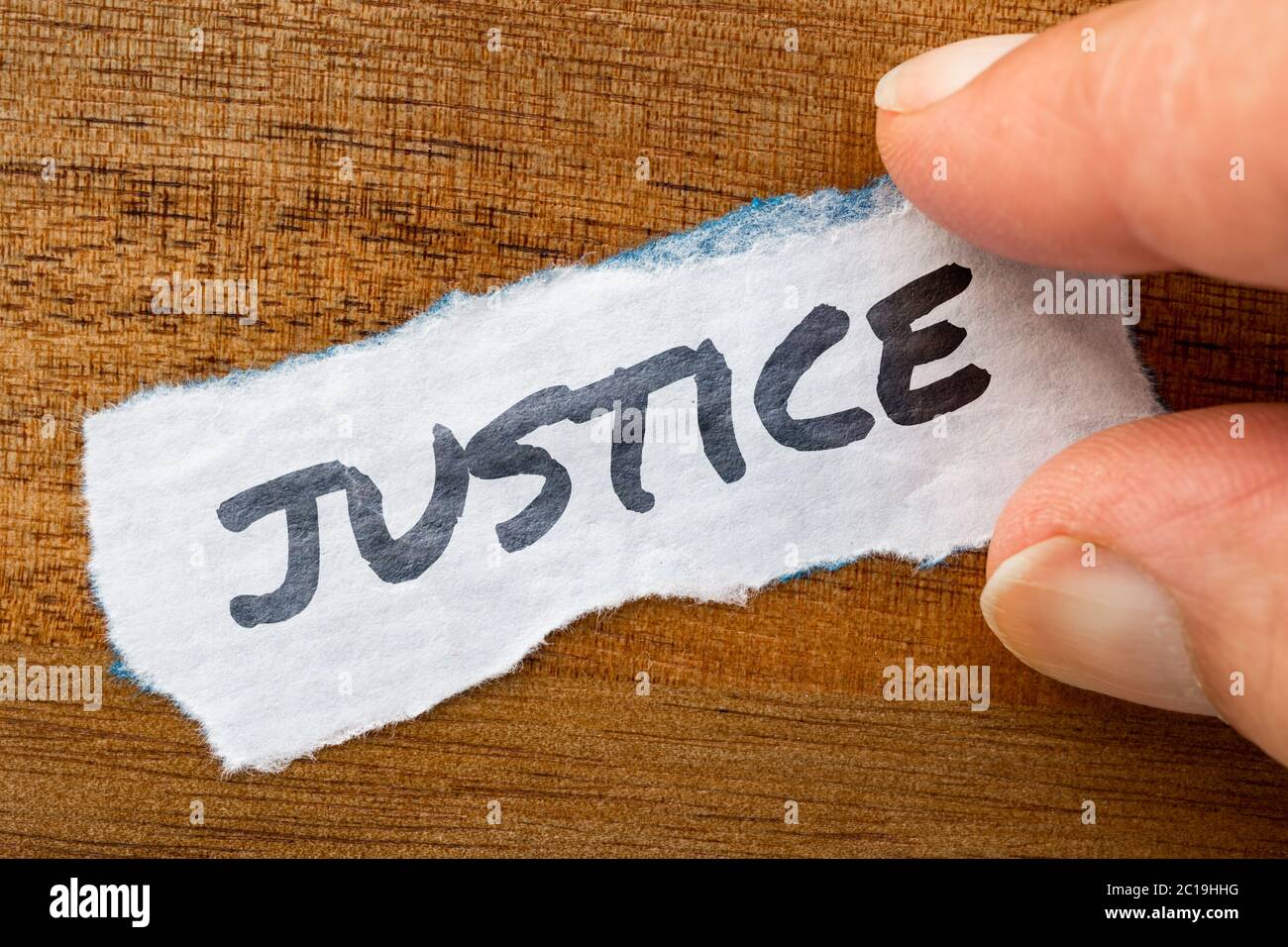 Justice concept and theme written on old paper on a grunge background Stock Photo