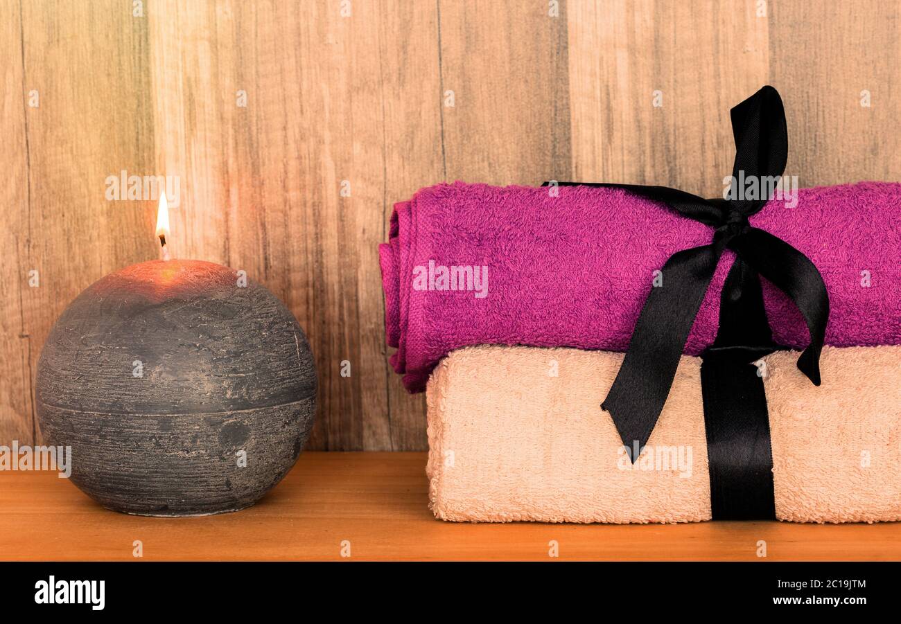 Towels with decorative candle. Beauty Spa Health and Wellness concept. Stock Photo