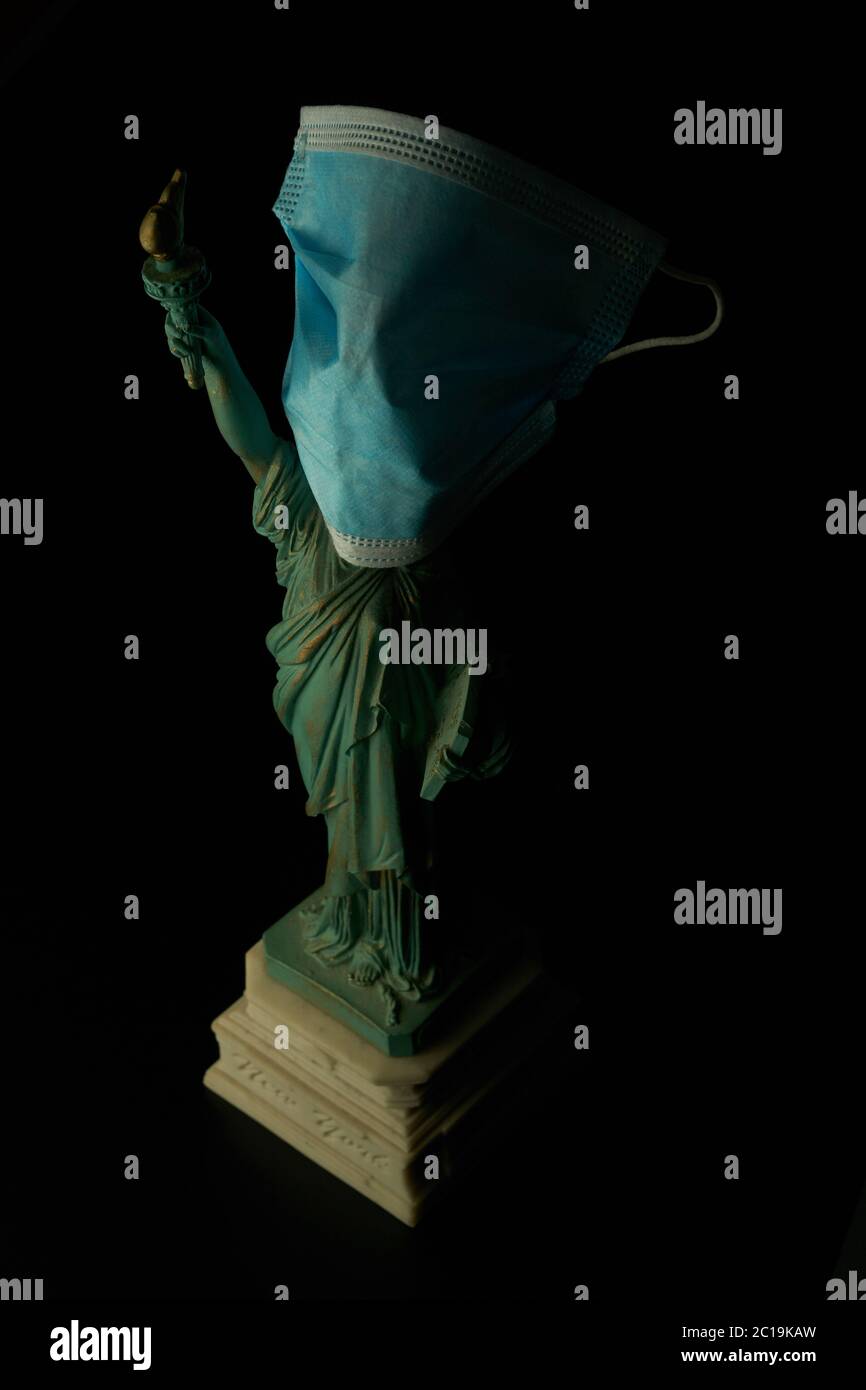 Covid-19 pandemic crisis concept. Statue of liberty with a medical mask. Stock Photo