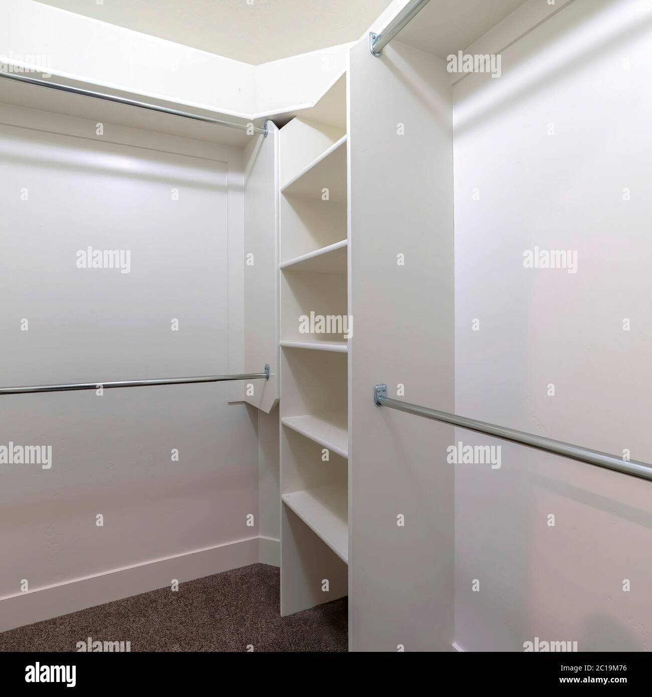 Square frame Hanging metal rods and storage shelves inside empty walk ...