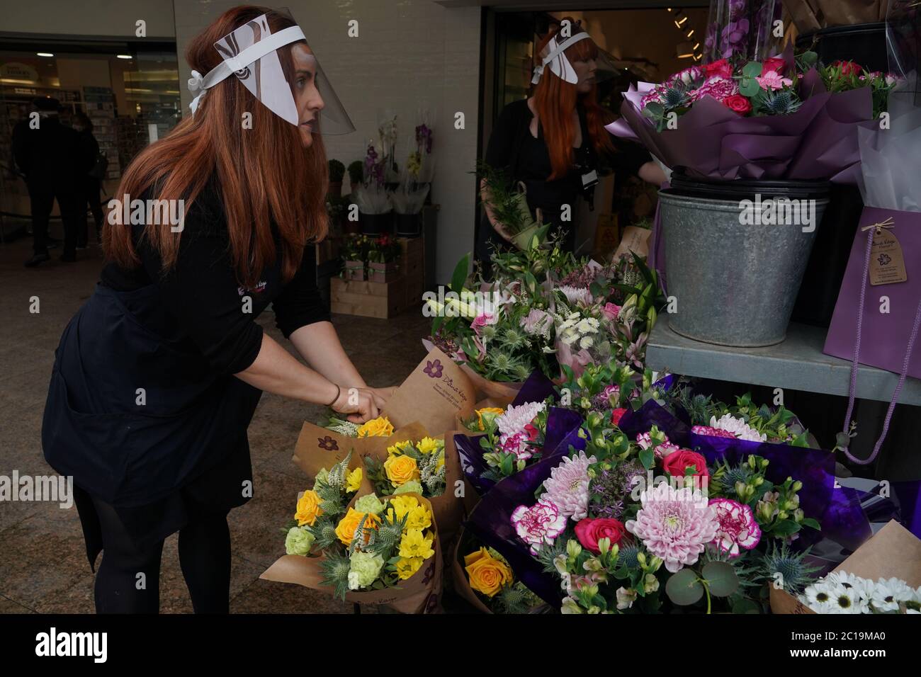 A Florist In A Face Mask Arranges Flowers Outside A Store In Newcastle As Non Essential Shops In England Open Their Doors To Customers For The First Time Since Coronavirus Lockdown Restrictions Were
