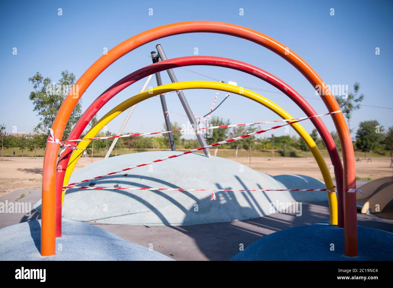 SPAIN, Seville: Life under quarantine during Corona Virus outbreak. Playgrounds for children and open air fitness places have been red taped since the Stock Photo