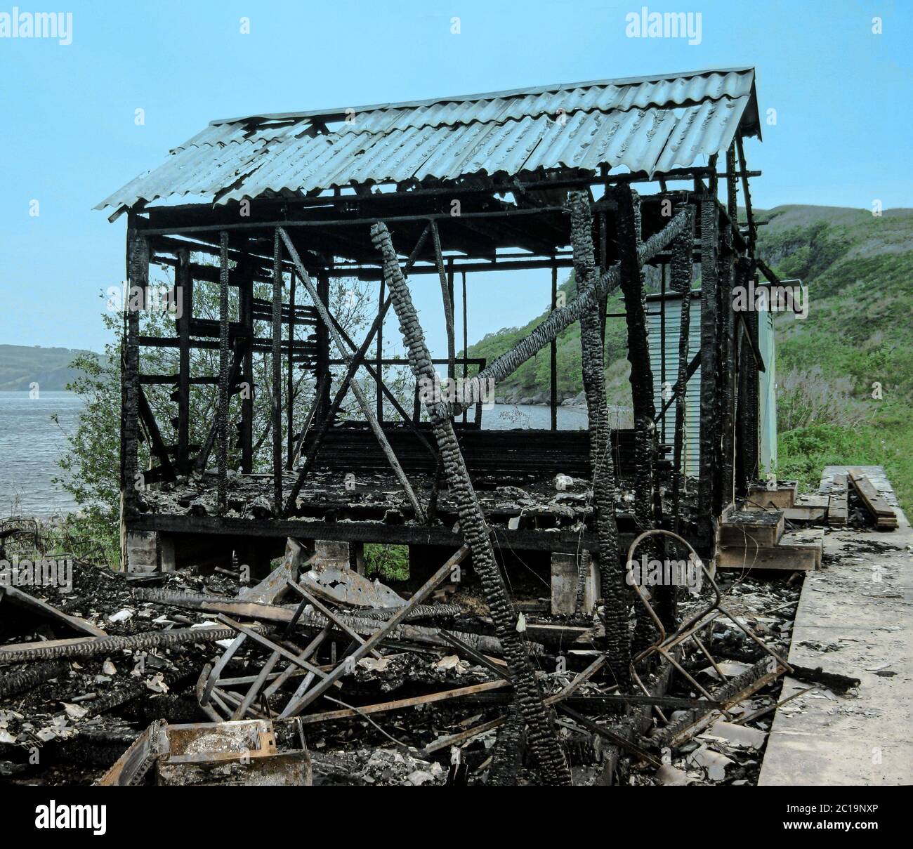 Burned village house. Burned down house, remnants of burned down