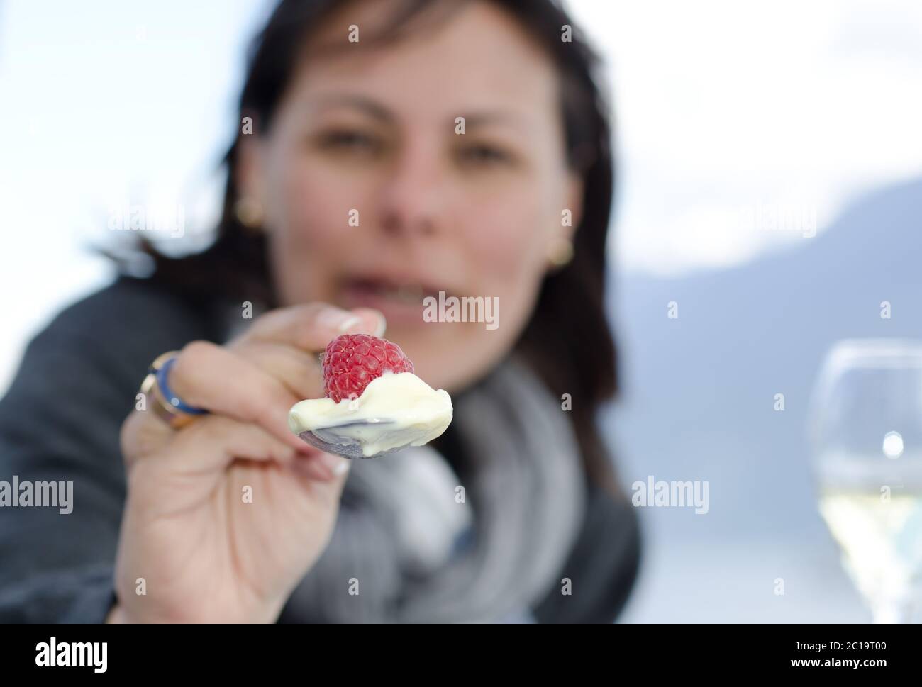 Woman Holdinga Spoon with Rraspberry and Ice Cream. Stock Photo