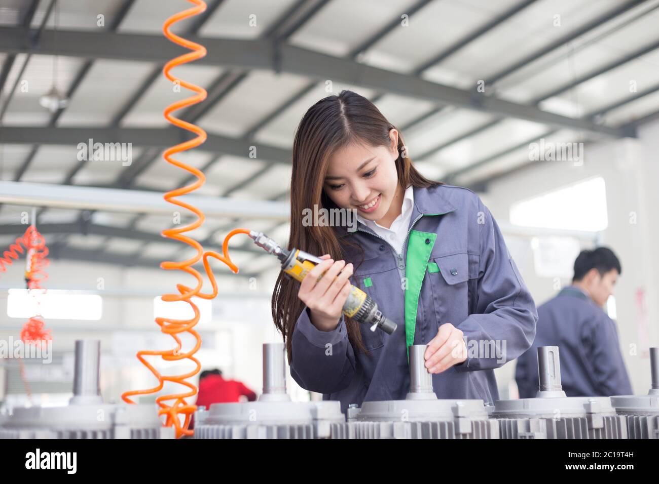 young asian woman works in workshop Stock Photo