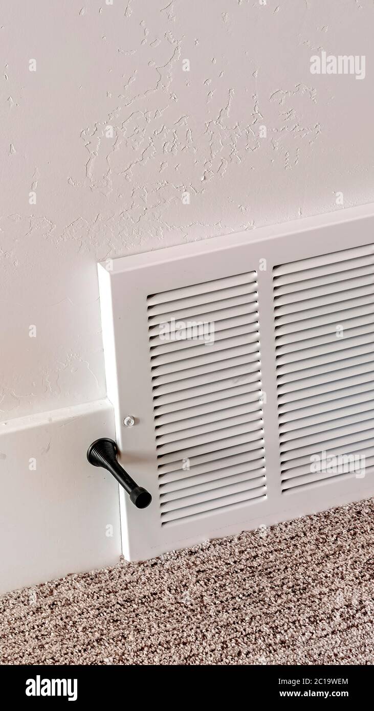 Vertical frame Air conditioner white plastic grille cover against wall