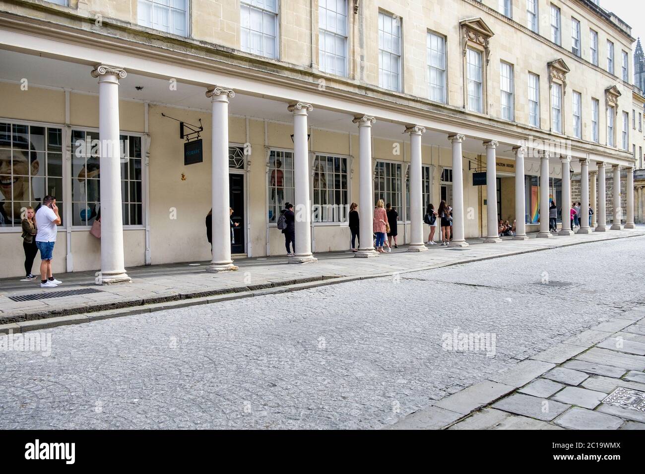 Bath, UK. 15th June, 2020. As non essential shops in England are given the green light by the government to reopen early morning shoppers in Bath waiting for the shops to open are pictured as they queue to get into Primark. Credit: Lynchpics/Alamy Live News Stock Photo