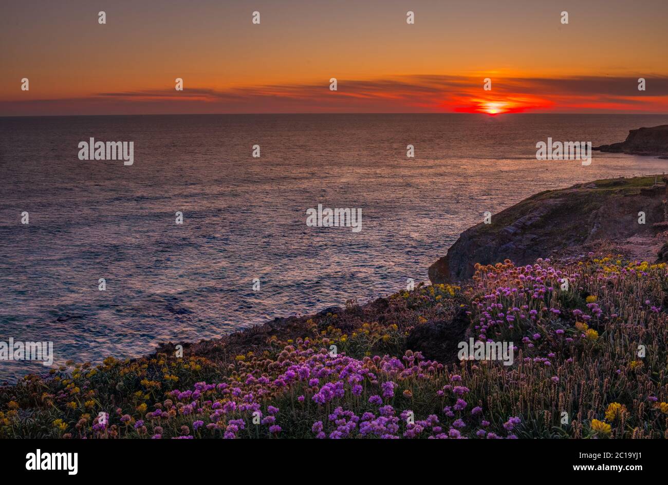 Sunset over the water at Bedruthan Steps Cornwall Stock Photo