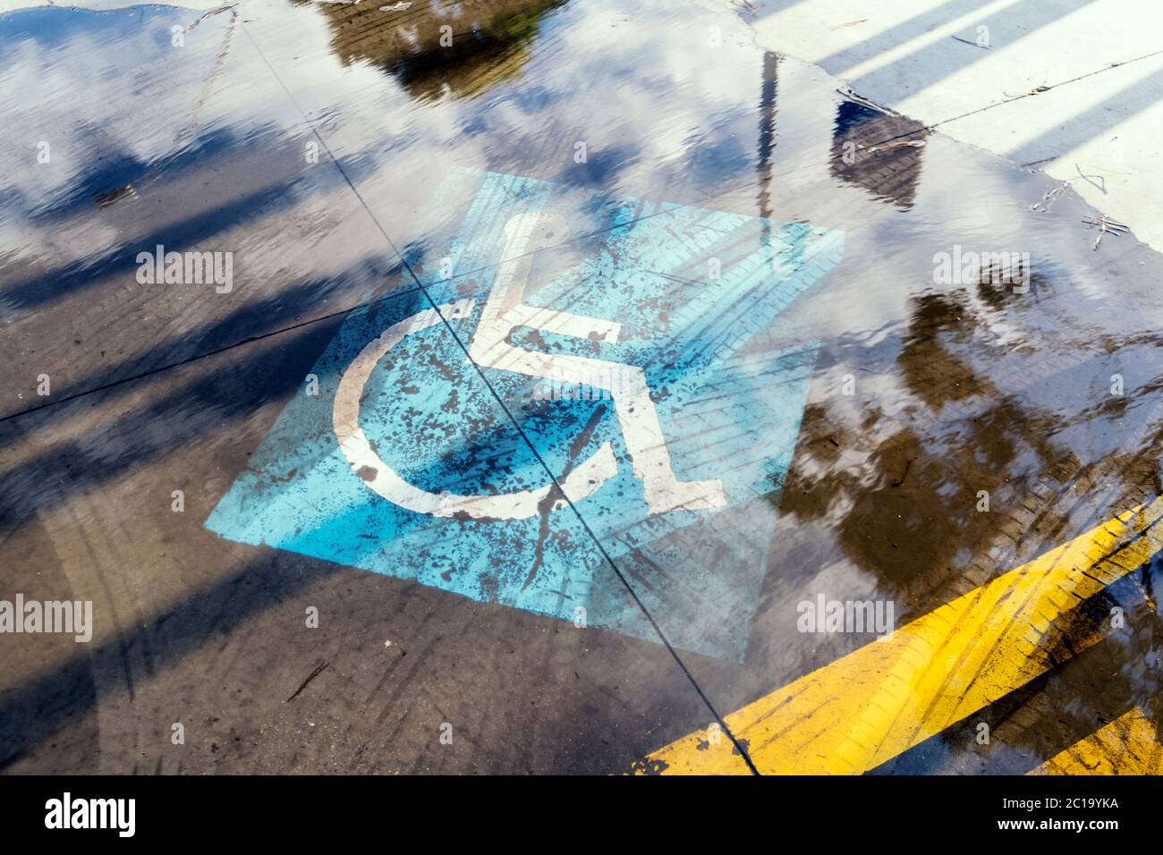 Flooded handicapped sign on the outdoor urban parking lot. Stock Photo