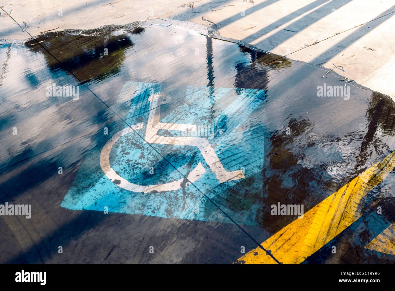 Flooded handicapped sign on the outdoor urban parking lot. Stock Photo