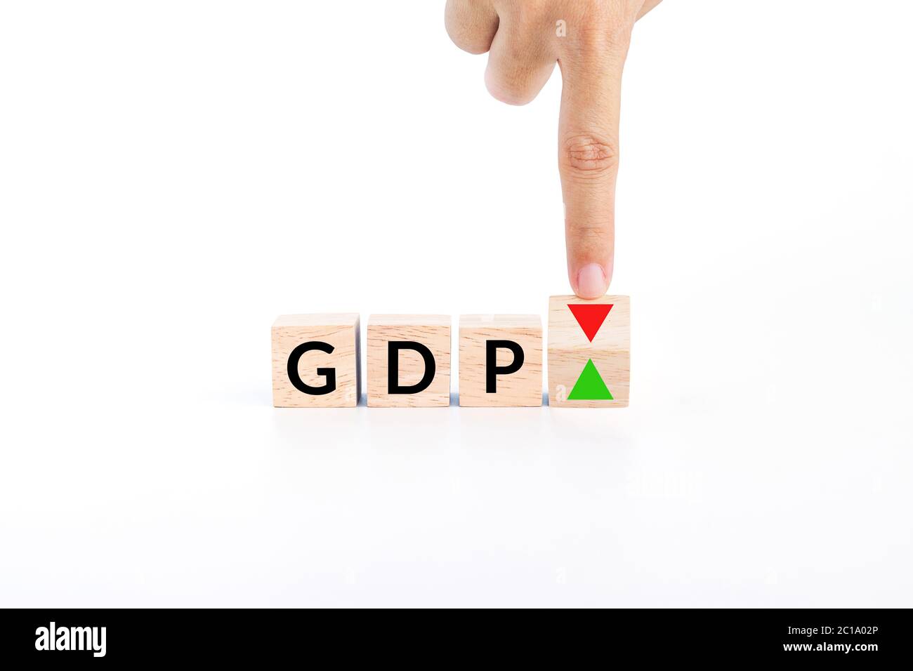 hand flip wooden cube to changes the direction of an arrow symbolizing that the GDP (gross domestic product) of a country is changing the trend Stock Photo