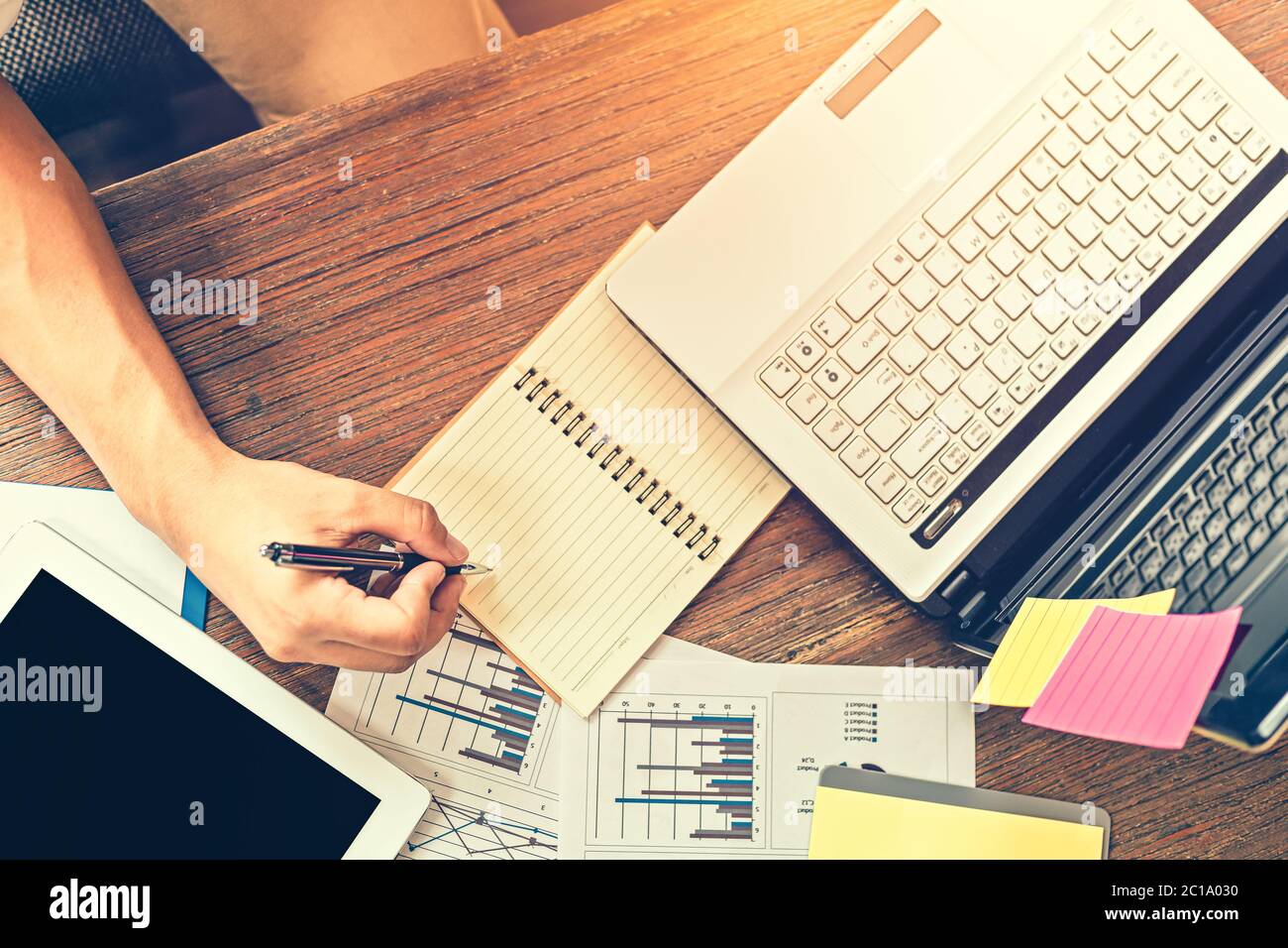 Businessman writing on paper graphs hi-res stock photography and images ...