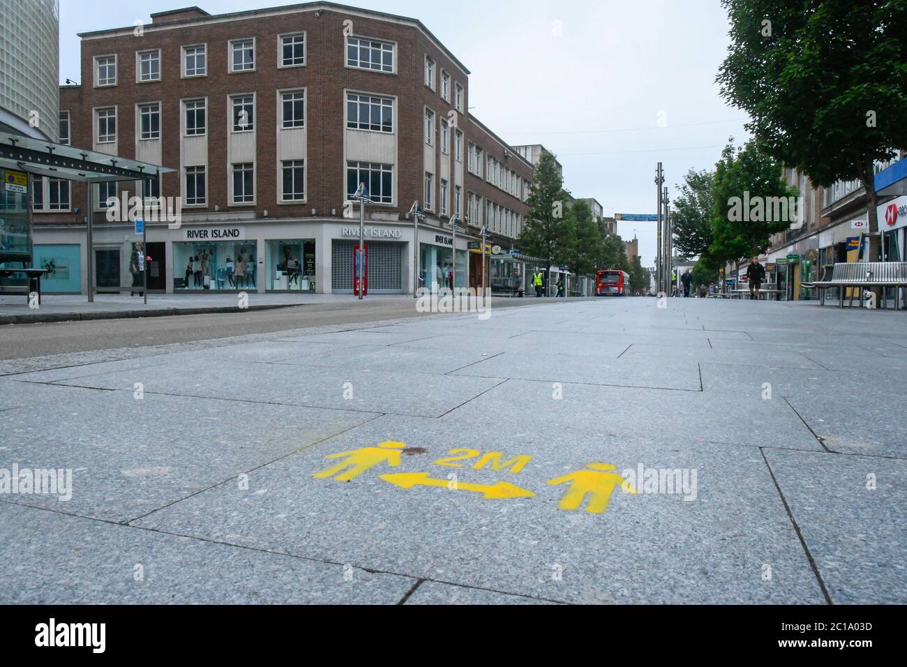 Exeter, Devon, UK.  15th June 2020.   Shops selling unessential items allowed to reopen today as coronavirus lockdown is eased further. Freshly painted social distancing marks painted on the pavement at Exeter in Devon.  Picture Credit: Graham Hunt/Alamy Live News Stock Photo