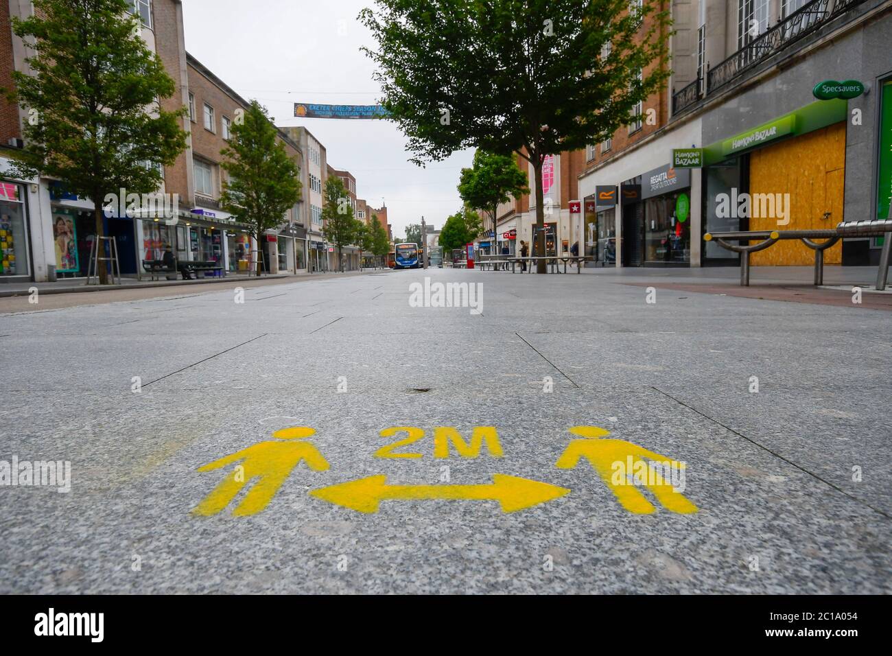 Exeter, Devon, UK.  15th June 2020.   Shops selling unessential items allowed to reopen today as coronavirus lockdown is eased further.  Freshly painted social distancing marks on the pavement in the High Street at Exeter in Devon ahead of the shops reopening.  Picture Credit: Graham Hunt/Alamy Live News Stock Photo