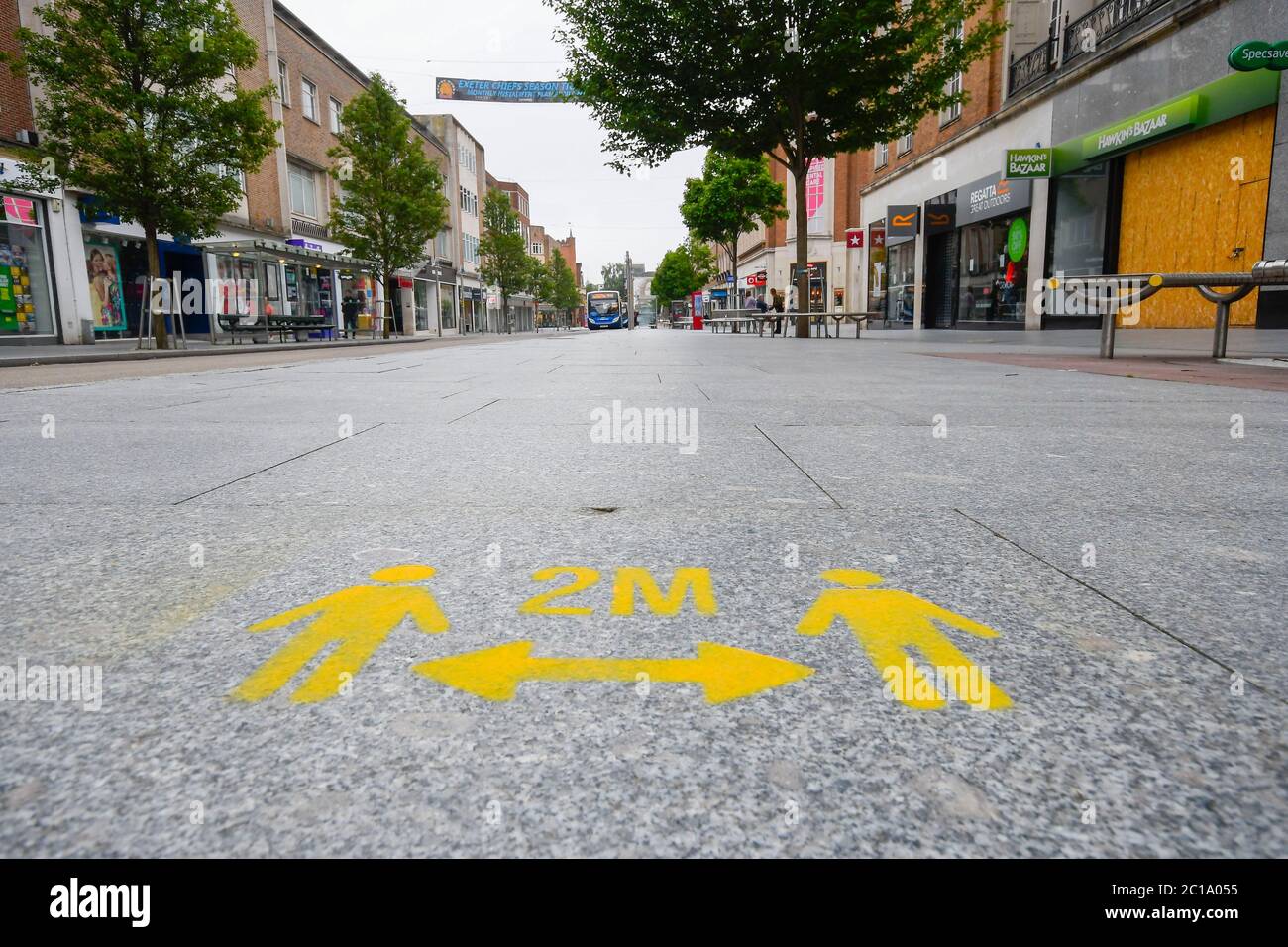 Exeter, Devon, UK.  15th June 2020.   Shops selling unessential items allowed to reopen today as coronavirus lockdown is eased further.  Freshly painted social distancing marks on the pavement in the High Street at Exeter in Devon ahead of the shops reopening.  Picture Credit: Graham Hunt/Alamy Live News Stock Photo