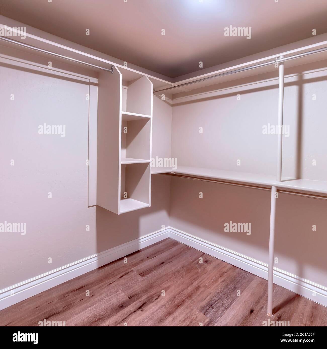 Square crop Spacious walk in closet of new home with metal rods shelves ...