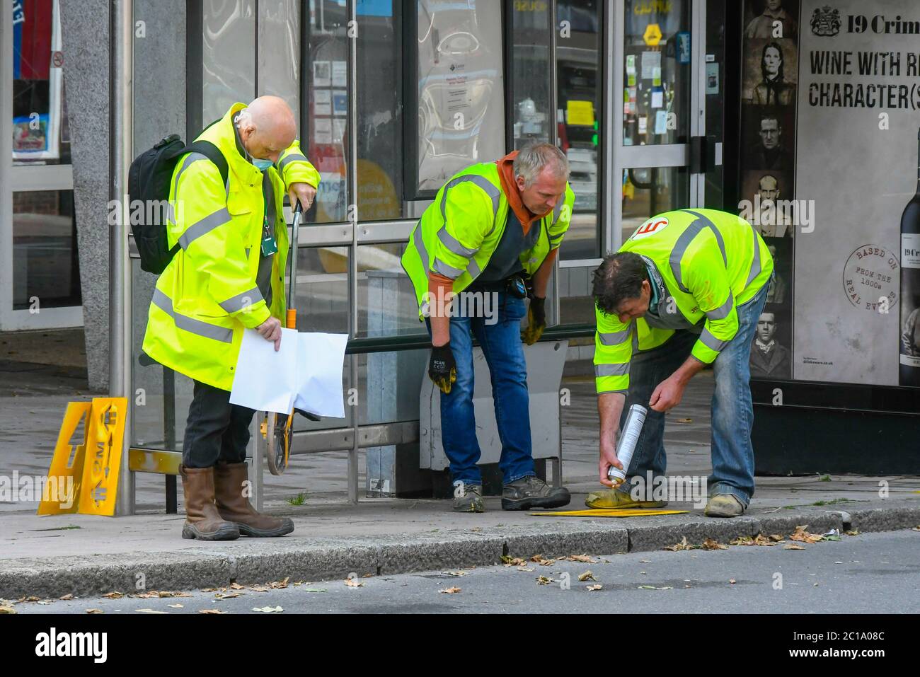 Exeter, Devon, UK.  15th June 2020.   Shops selling unessential items allowed to reopen today as coronavirus lockdown is eased further.  Council staff members painting social distancing and one way arrows on the pavement in the High Street at Exeter in Devon ahead of the reopening of the shops. Picture Credit: Graham Hunt/Alamy Live News Stock Photo