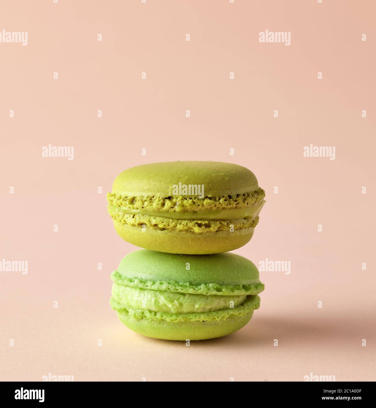 stack of colorful macaroons isolated on beige background Stock Photo