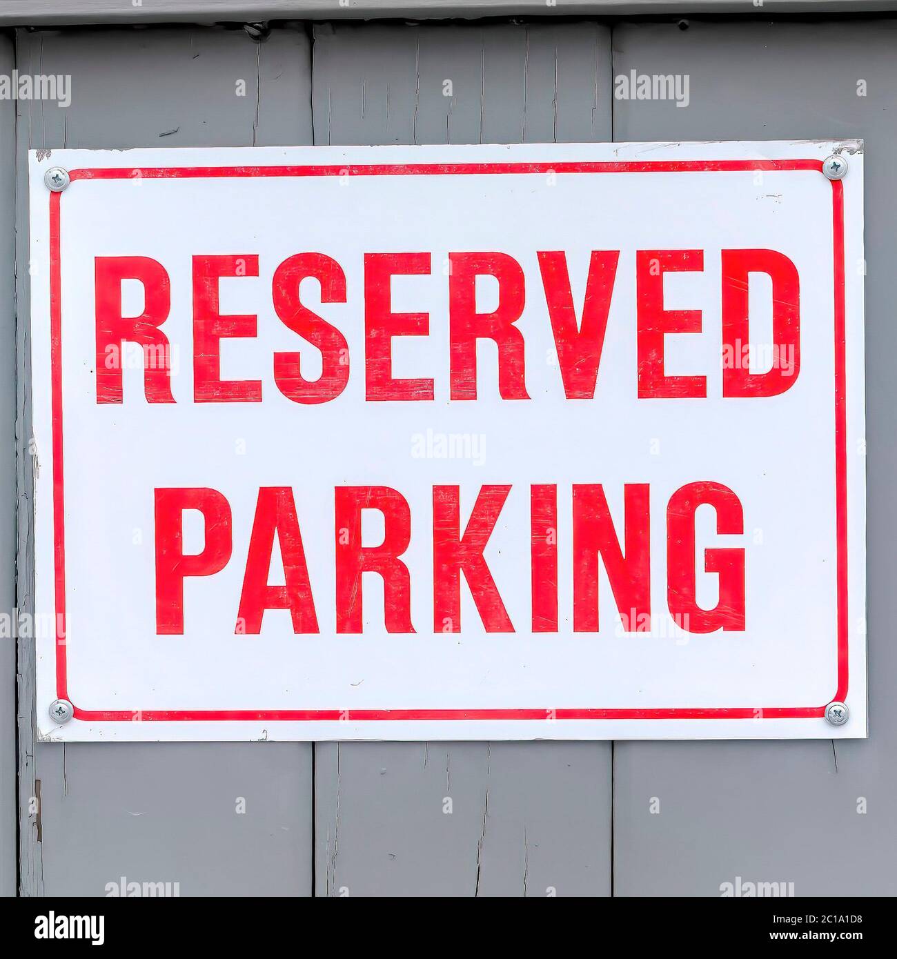 Square Reserved Parking sign board on a gray wooden wall topped with snow  in winter Stock Photo - Alamy