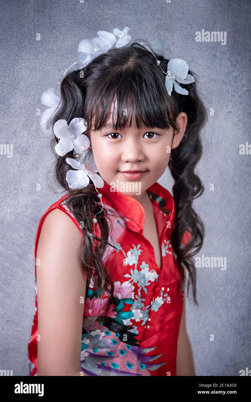Portrait of asian little girl in red dress Stock Photo - Alamy