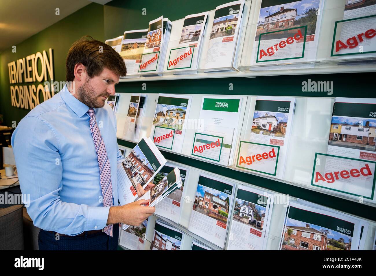 Templeton robinson estate agent brent howell setting out brochures hi