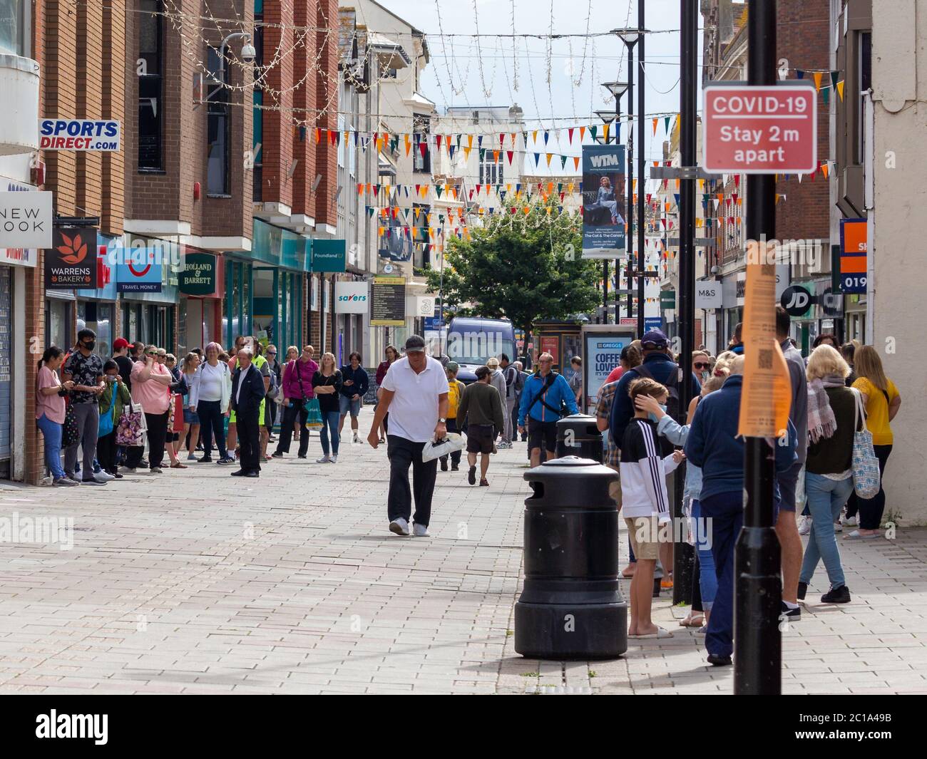 Worthing, Sussex, UK; 15th June 2020; Queue of People Waiting For sports Direct to Open For the first time since the Covid-19 Pandemic Lockdown Stock Photo