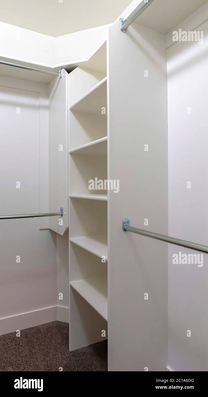Vertical Hanging metal rods and storage shelves inside empty walk in ...