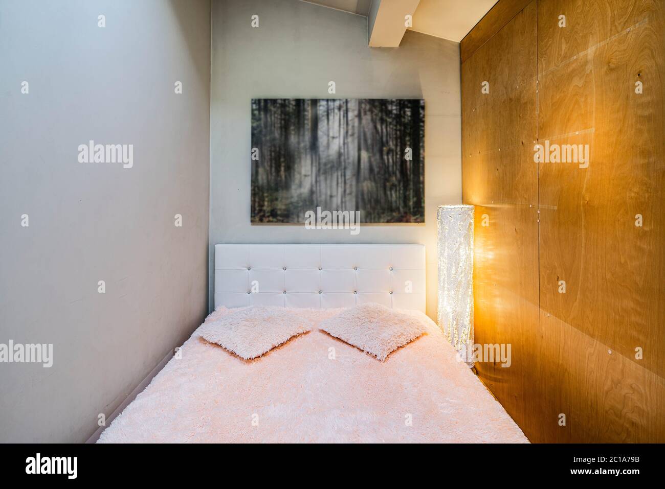 Small bed behind wooden sliding doors. Place for sleeping. Blurred