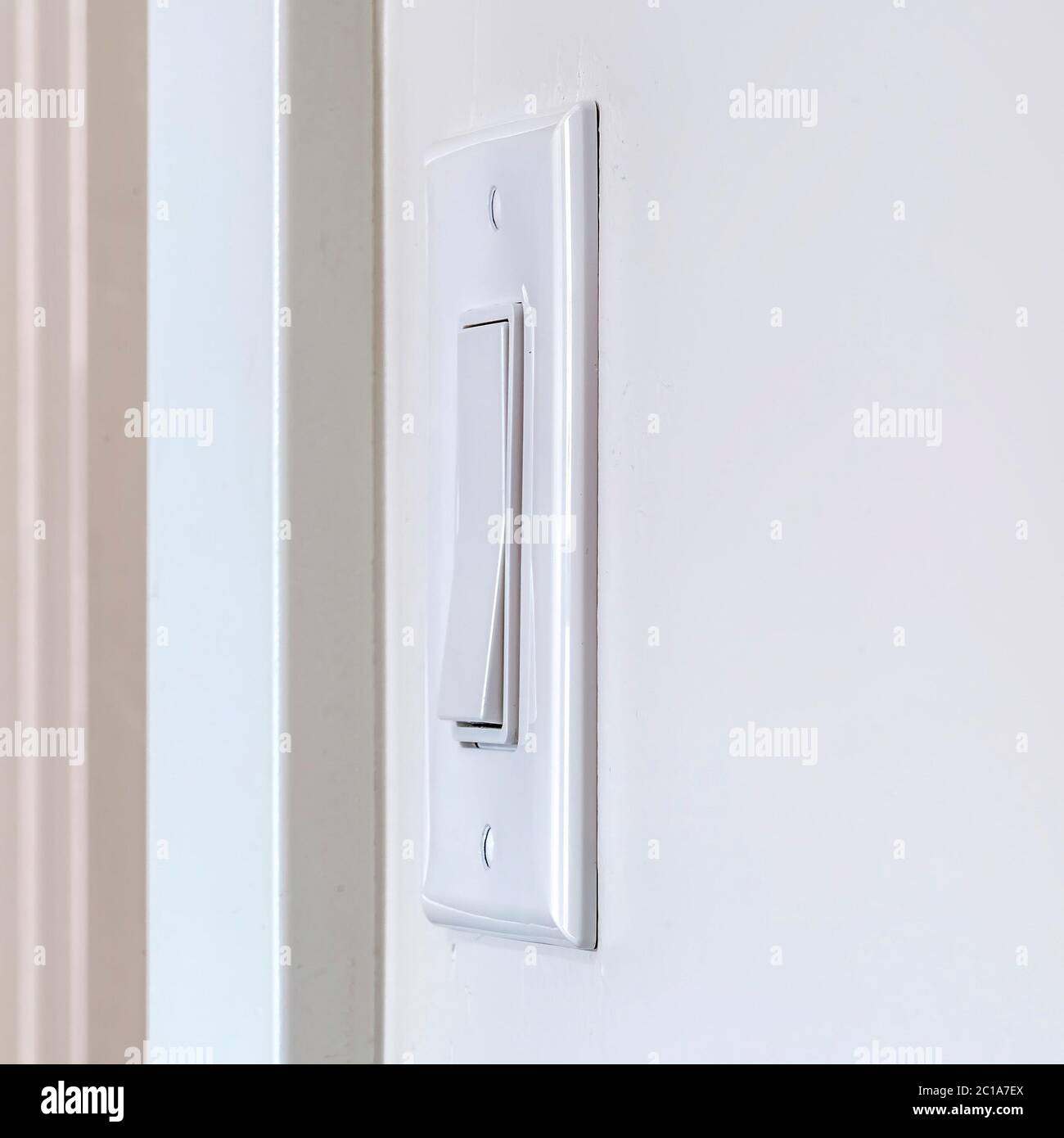 Square frame Side view of electrical rocker light switch mounted on