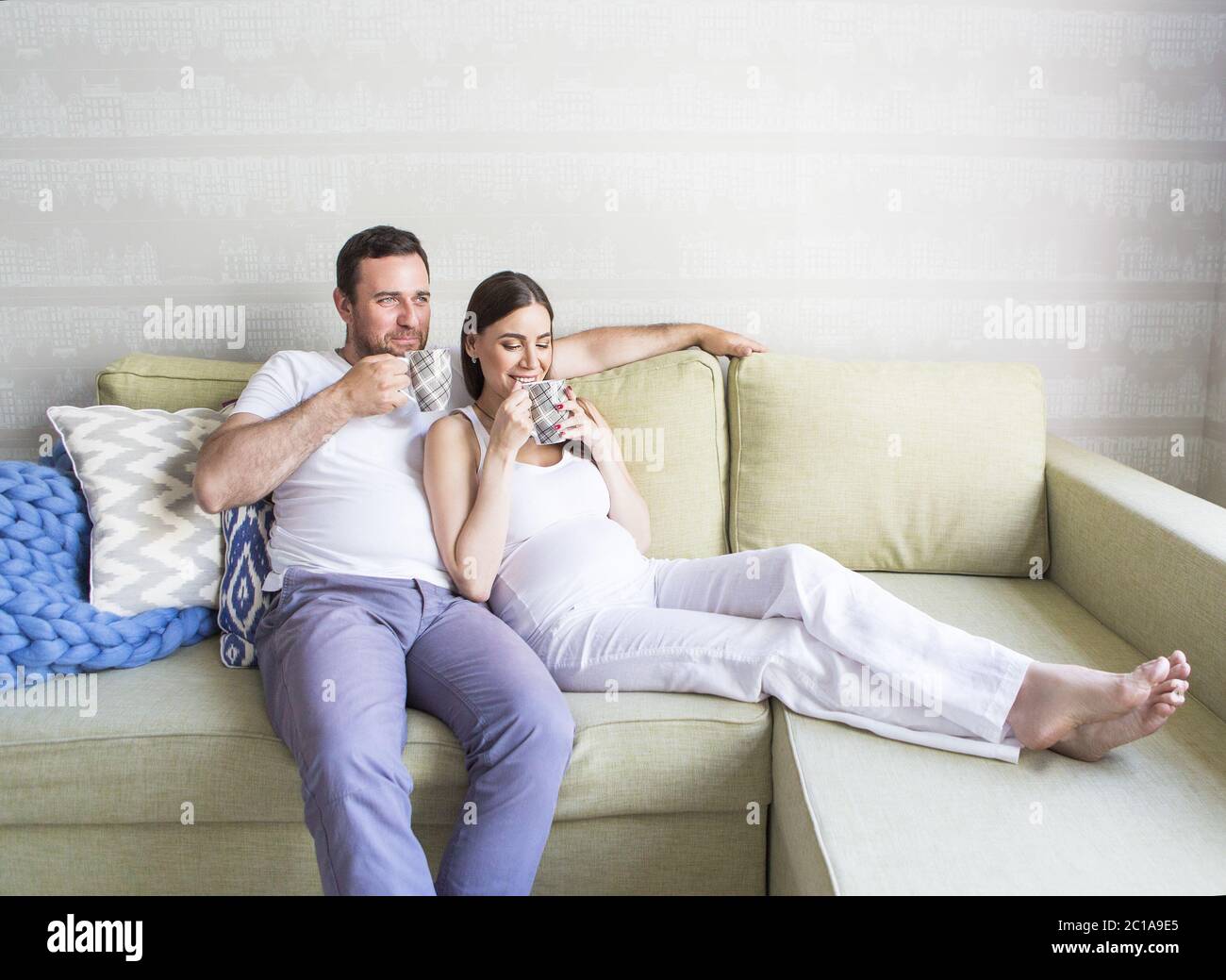 Pregnant woman and young man together indoors Stock Photo - Alamy