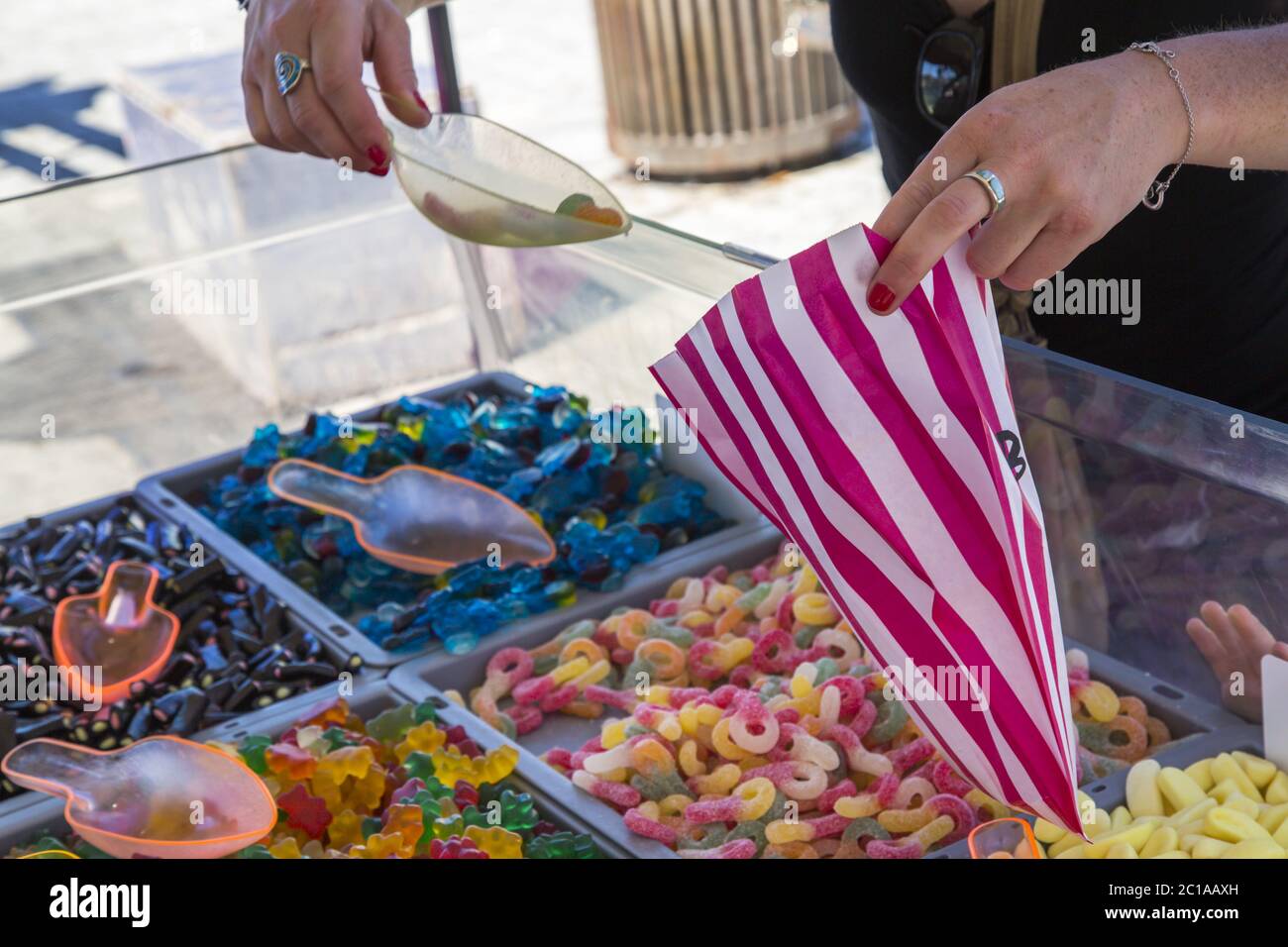 Hand holding bag of sweets hi-res stock photography and images - Alamy