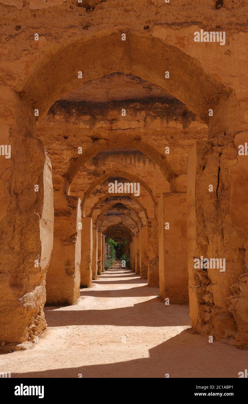 The medieval ruined arches of the massive Heri es-Souani Royal Stables and Granaries of Moulay Ismail in the Imperial City of Meknes, Morocco. Stock Photo