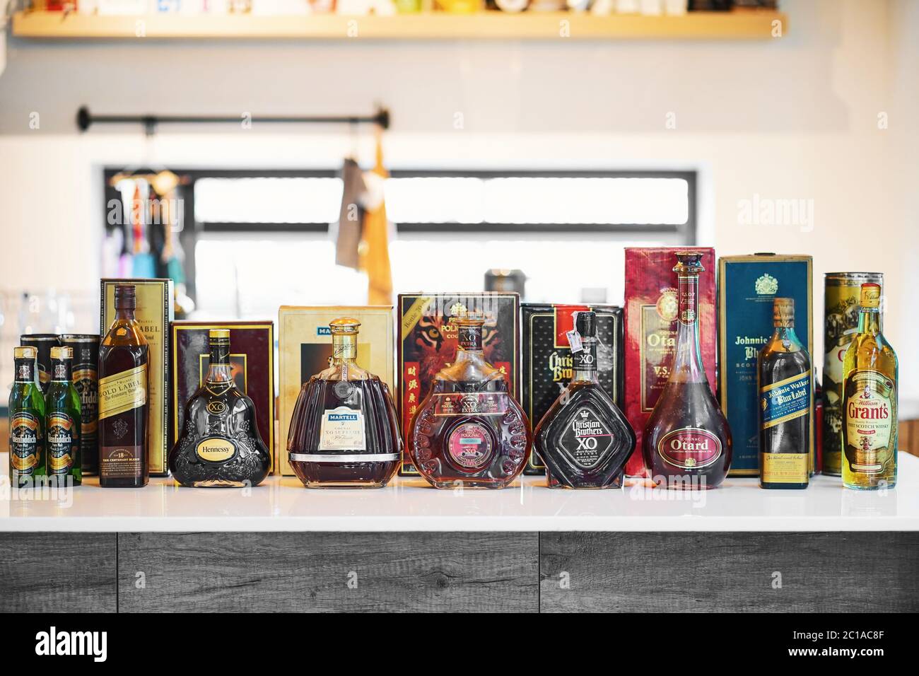 BANGKOK, THAILAND - May 2, 2020 : Many Bottles of old vintage several global whiskey brands on the kitchen table, include liqueur alcohol and whiskey. Stock Photo