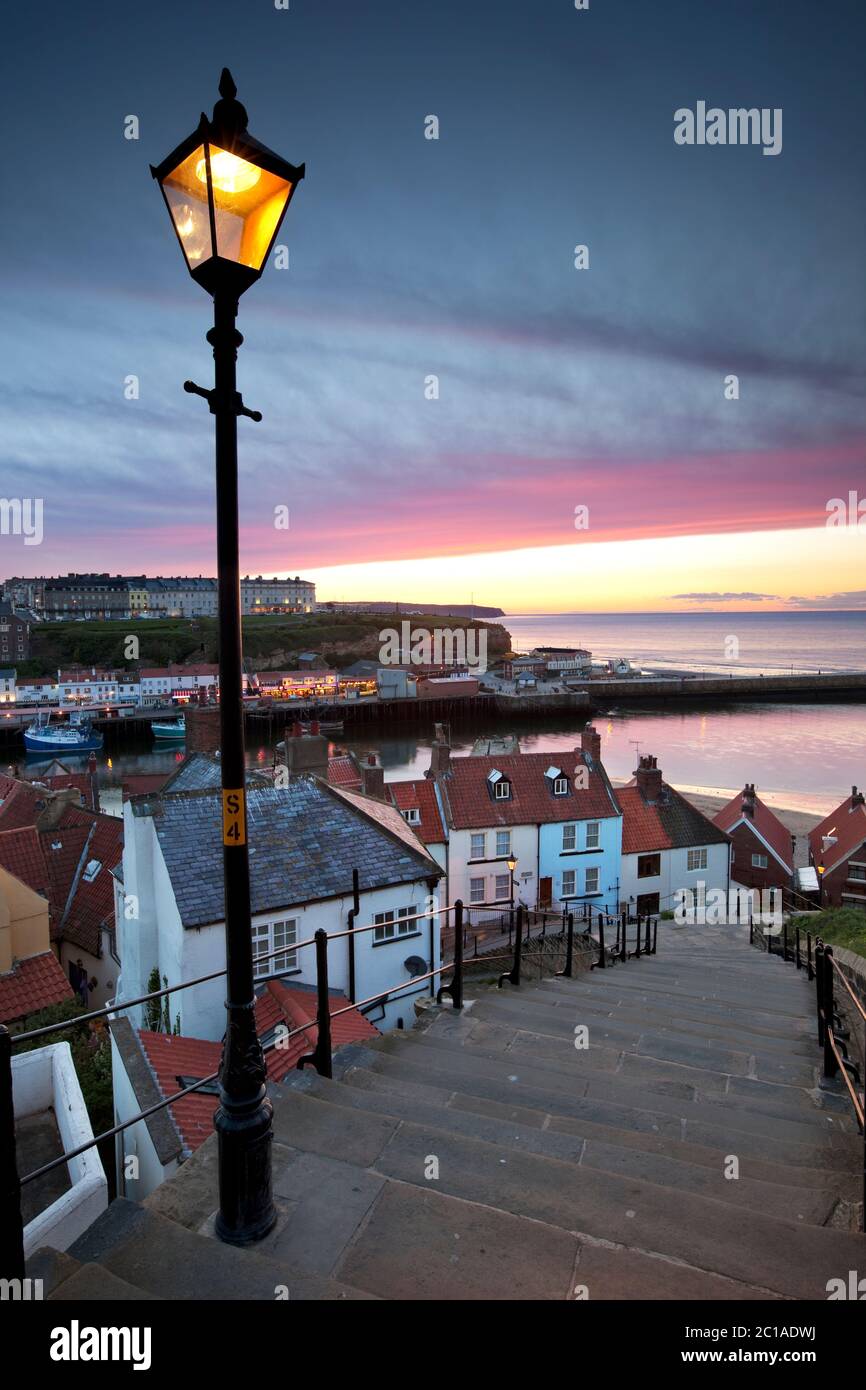 Looking down steep steps at dusk over the Old Town and West Cliff, Whitby, North Yorkshire, England, United Kingdom, Europe Stock Photo