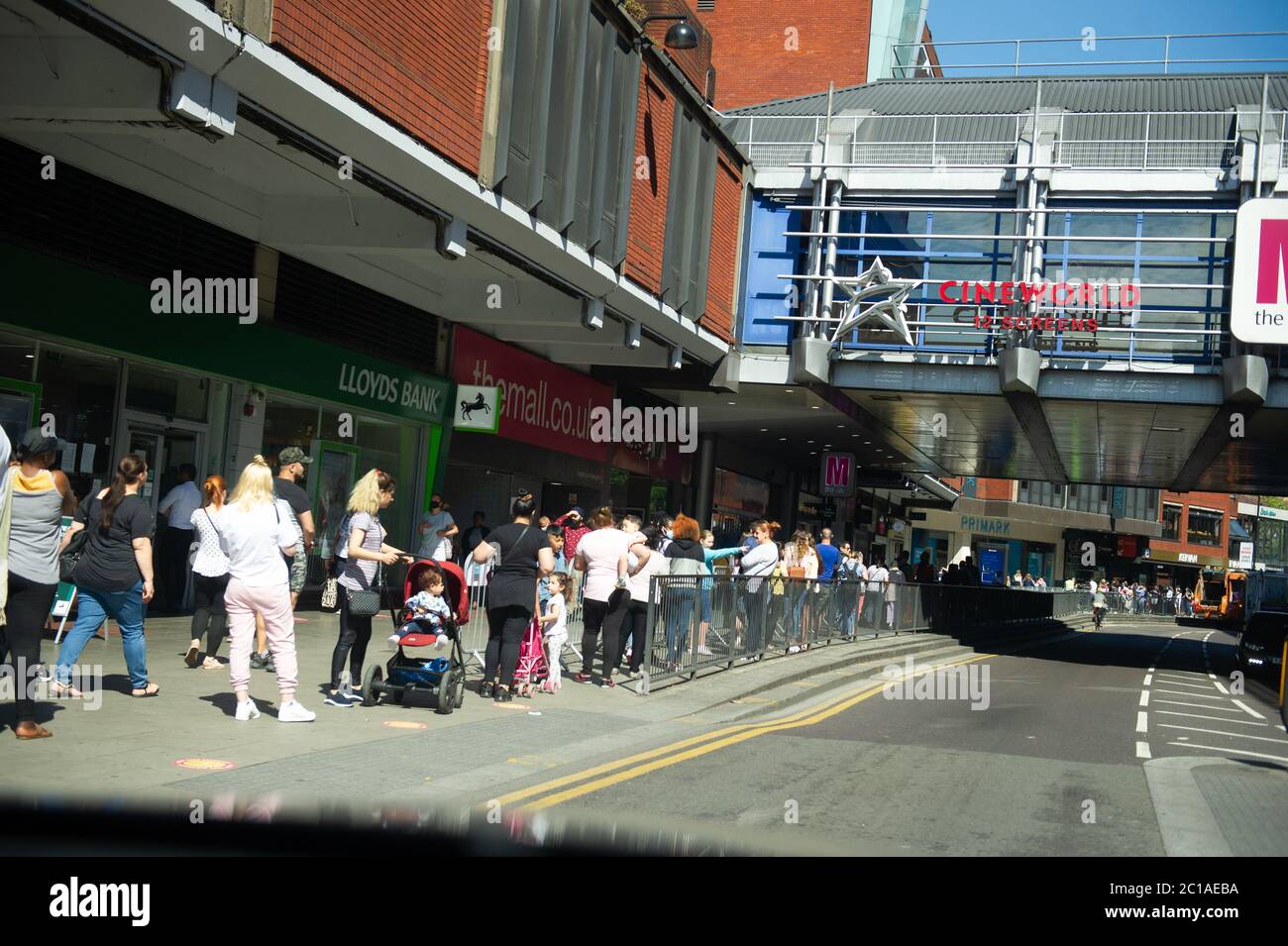 shoppers queue outside JD sports with Primark bags Stock Photo Alamy
