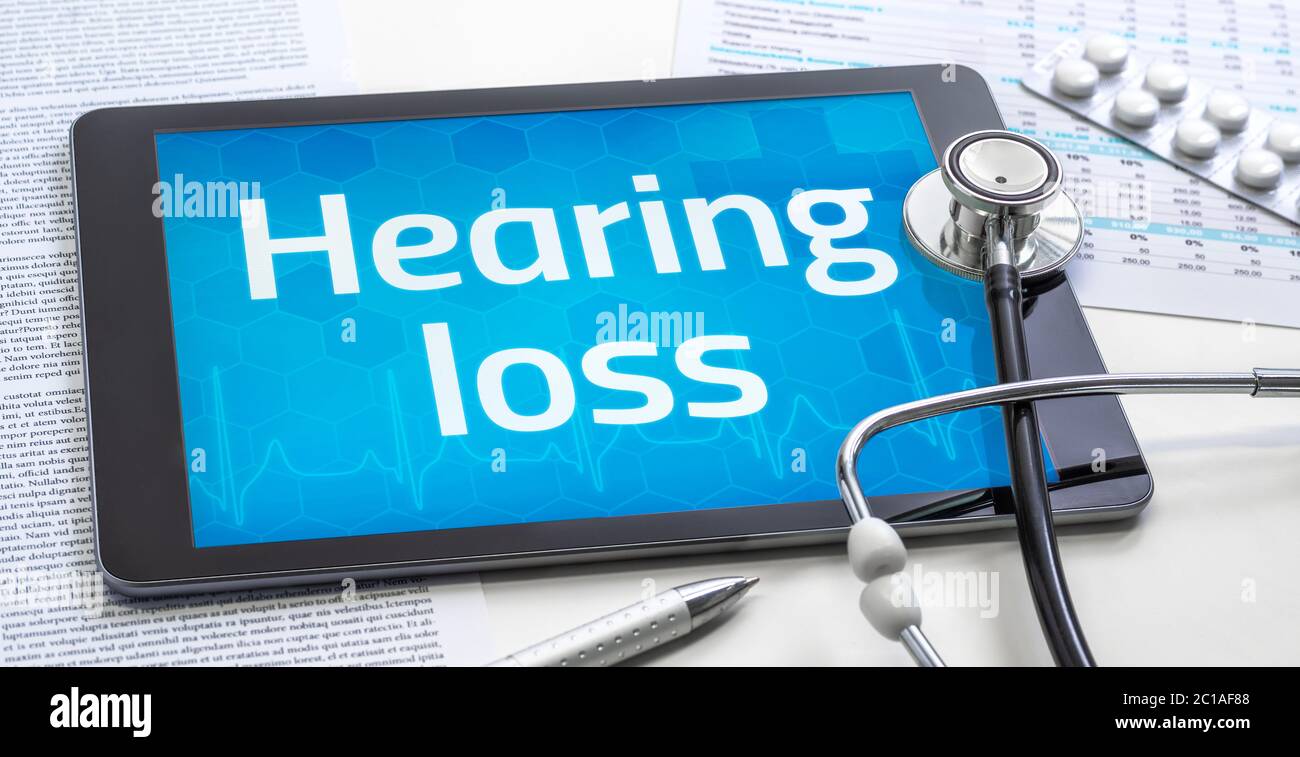 The word Hearing loss on the display of a tablet Stock Photo