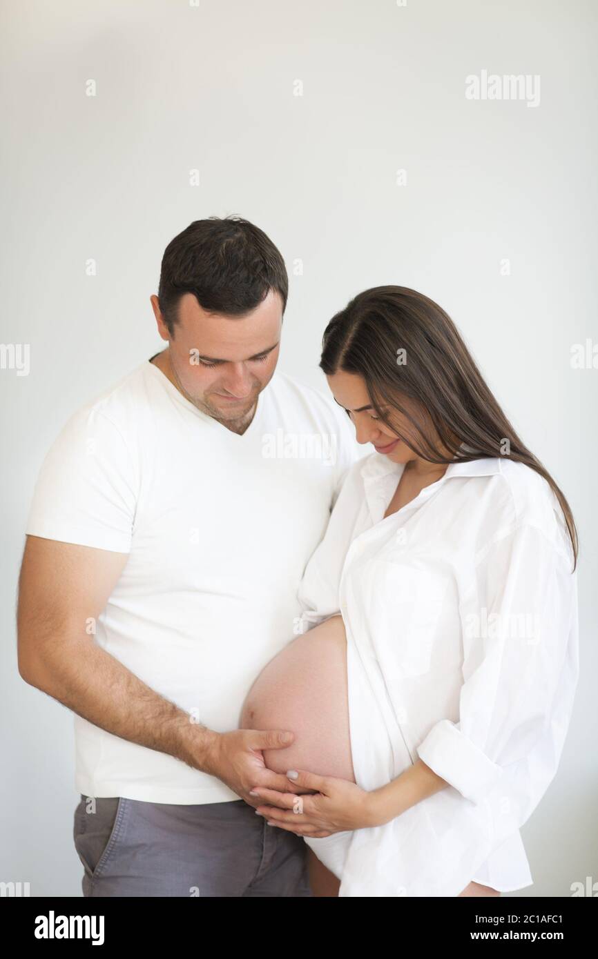 Pregnant woman and young man together indoors Stock Photo - Alamy