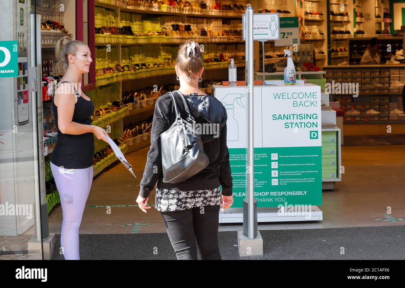 Bournemouth, UK. 15th June 2020. A sanitising station at the entrance of  the Deichmann store as customers head back to the shops in Bournemouth as  non essential retail shops reopen after three