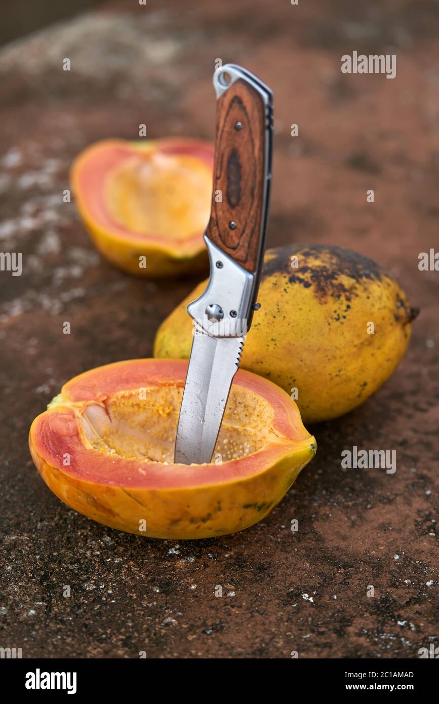 Tasty papayas and knife Stock Photo