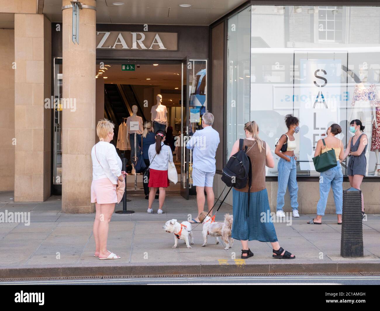 Cambridge, UK. 15th June, 2020. Customers queue outside Zara clothes shop.  Non essential retail shops open for the first time in three months after  the coronavirus lockdown. Credit: Julian Eales/Alamy Live News